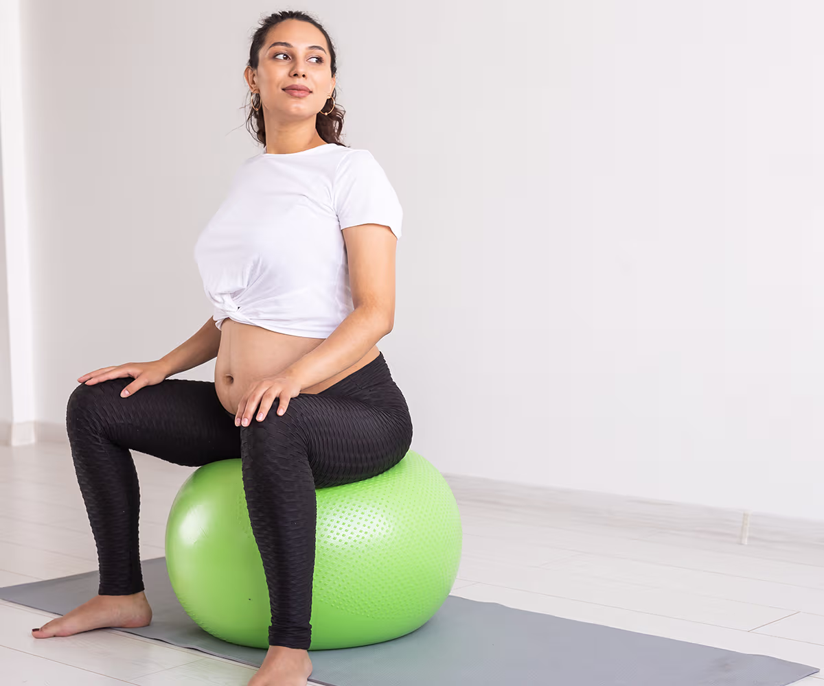 Exercise During Pregnancy accent image showing a pregnant woman using an exercise ball