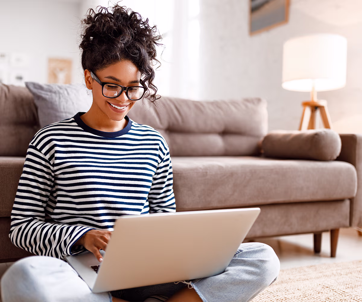 Patient Resources Accent image showing a woman using a laptop at home